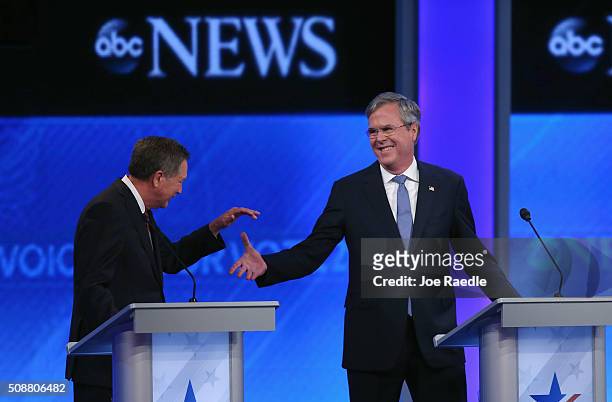 Republican presidential candidates Ohio Governor John Kasich and Jeb Bush shake hands during the Republican presidential debate at St. Anselm College...