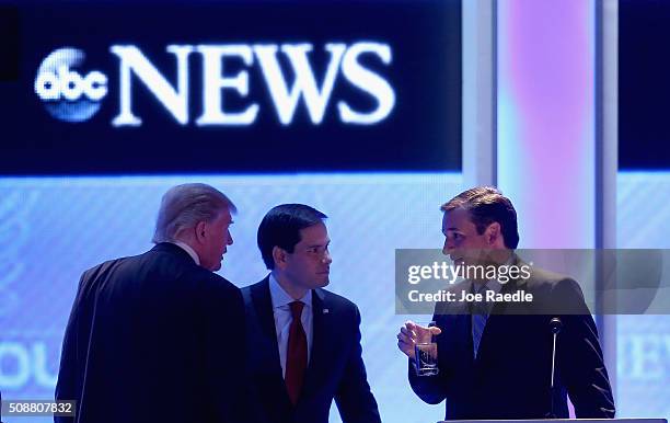 Republican presidential candidates Donald Trump, Sen. Marco Rubio and Sen. Ted Cruz talk during a commercial break in the Republican presidential...