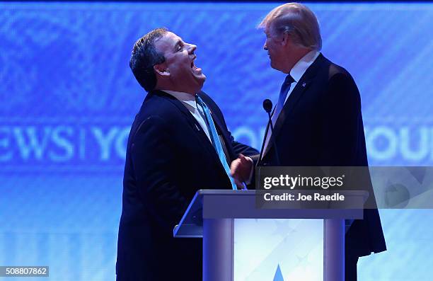 Republican presidential candidates New Jersey Governor Chris Christie and Donald Trump share a laugh during a commercial break in the Republican...