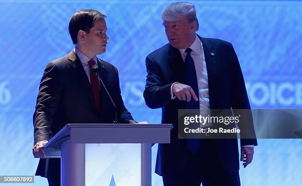 Republican presidential candidates Sen. Marco Rubio and Donald Trump visit during commercial break in the Republican presidential debate at St....
