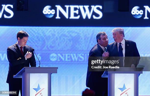 Republican presidential candidates New Jersey Governor Chris Christie and Donald Trump visit as Sen. Marco Rubio stands close by during a commercial...