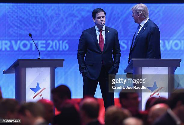 Republican presidential candidates Sen. Marco Rubio and Donald Trump talk during a commercial break in the Republican presidential debate at St....
