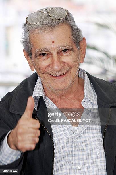 Egyptian director Youssef Chahine gives a thumbs-up sign during a photo call for his film "Alexandria...New York", 21 May 2004, at the 57th Cannes...