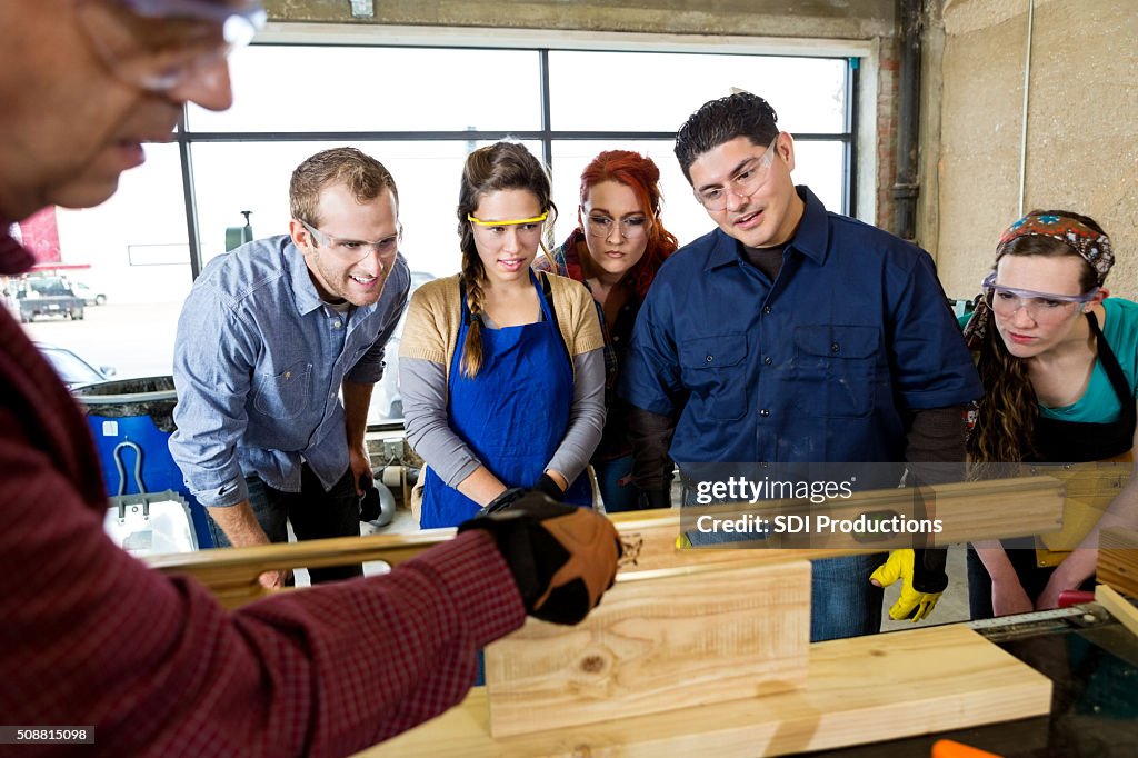 Workshop manager uses leveler tool in workshop