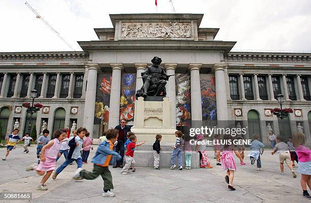 Children play around the statue of Velasquez in front of the Prado museum 21 May 2004 in Madrid. Spanish Crown Prince Felipe of Bourbon will marry...