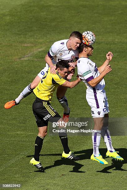 Shane Lowry of the Glory wins a header over teammate Krisztian Vadocz and Blake Powell of the Phoenix during the round 18 A-League match between...