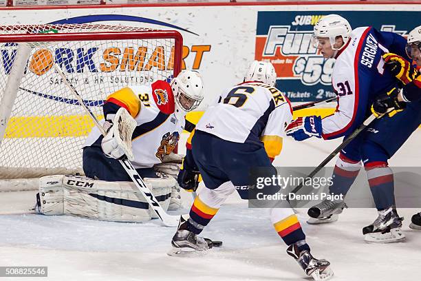 Defenceman Mikhail Sergachev of the Windsor Spitfires drives the net against goaltender Devin Williams of the Erie Otters on February 6, 2016 at the...