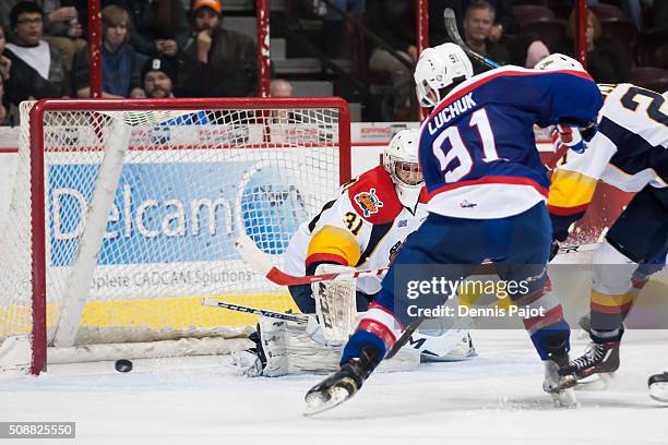 Goaltender Devin WIlliams of the Erie Otters watches a rebound against forward Aaron Luchuk of the Windsor Spitfires on February 6, 2016 at the WFCU...