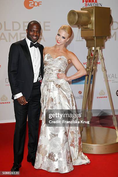 Hans Sarpei and Kathrin Menzinger attend the Goldene Kamera 2016 show on February 6, 2016 in Hamburg, Germany.