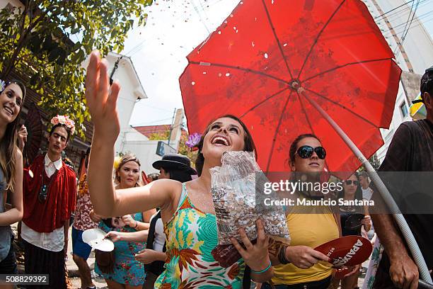 Revelers have fun during the street carnival. Street carnival in Sao Paulo, many groups, called blocos, has bands and thousands of revelers ,...