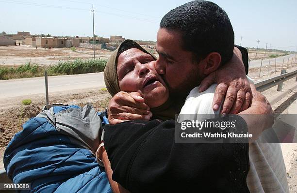 Freed Iraqi prisoner kisses his mother after being released from Abu Ghraib prison May 21, 2004 outside of Baghdad, Iraq. More than 400 prisoners...