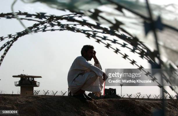 An Iraqi man waits for the release of his relative detained in the Abu Ghraib prison May 21, 2004 outside of Baghdad, Iraq. More than 400 prisoners...