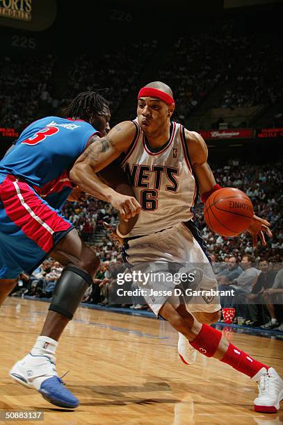 Kenyon Martin of the New Jersey Nets drives around Ben Wallace of the Detroit Pistons in Game six of the Eastern Conference Semifinals during the...