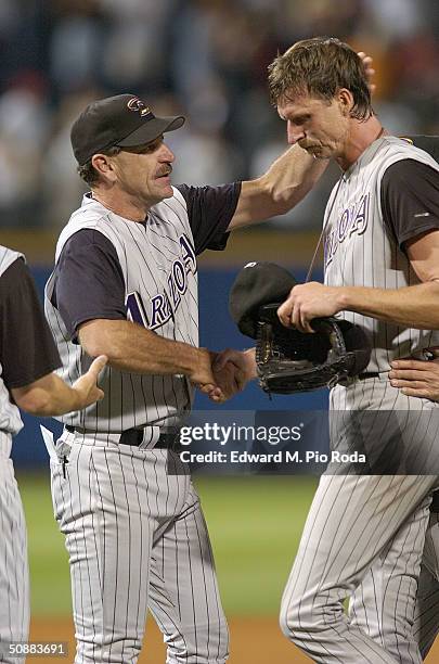 Manager Bob Brenly of the Arizona Diamondbacks congratulates Randy Johnson for pitching a perfect game against the Atlanta Braves on May 18, 2004 at...