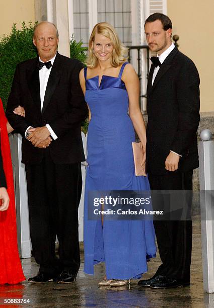 Norwegian Crown Prince Haakon and his wife Crown Princess Mette-Marit pose for a picture with King Harald V as they arrive to attend a gala dinner at...