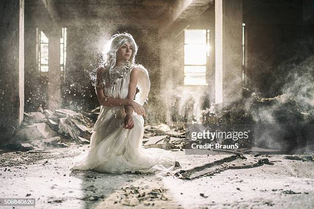 beautiful female angel in an old ruin. - angel dust stock pictures, royalty-free photos & images