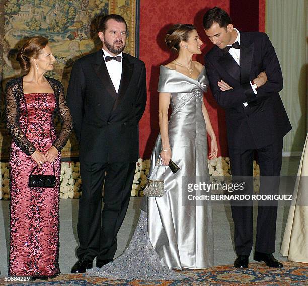 Prince Felipe of Spain talks to his fiancee Letizia Ortiz as they pose with Jesus Ortiz and Paloma Rocasolano, at the Pardo Palace in Madrid for an...