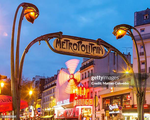 famous moulin rouge and metro sign at night, paris, france - the place pigalle in paris stock pictures, royalty-free photos & images