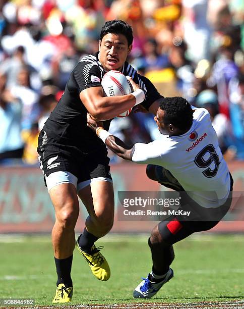 Ben Lam of New Zealand brushes off the tackle of Jerry Tuway of Fiji during the 2016 Sydney Sevens match between Fiji and New Zealand at Allianz...