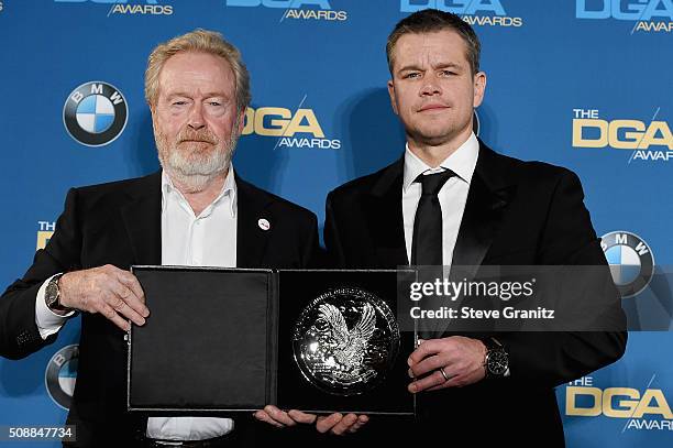 Director Ridley Scott, recipient of the Feature Film Nomination Plaque for The Martian and actor Matt Damon pose in the press room during the 68th...