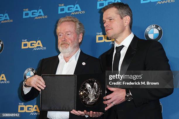 Director Ridley Scott, recipient of the Feature Film Nomination Plaque for The Martian and actor Matt Damon pose in the press room during the 68th...