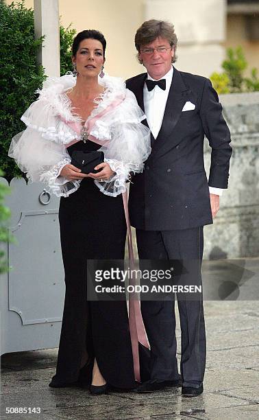 Princess Caroline of Monaco and her husband German Prince Ernst August of Hanover pose for photographers as they arrive to attend an official diner...