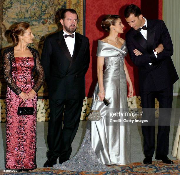 Spanish Crown Prince Felipe and his fiancee Letizia Ortiz Rocasolano pose for a picture with her father Jesus Ortiz and mother Paloma Rocasolano as...
