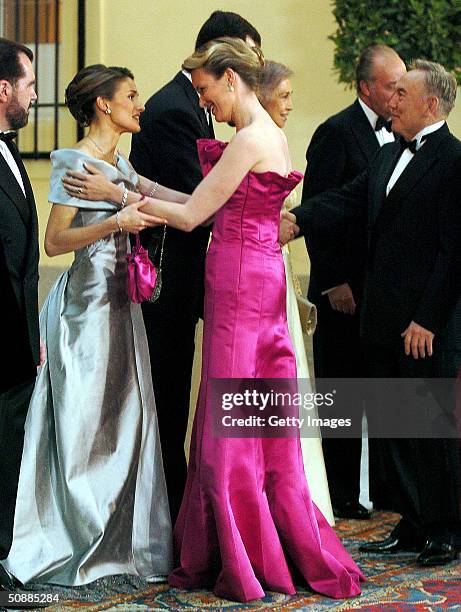 Princess Mathilde of Belgium greets Letizia Ortiz Rocasolano, fiancee of Spanish Crown Prince Felipe, as she arrives to attend a gala dinner at El...