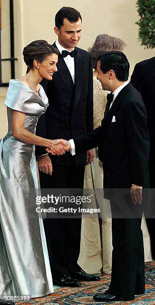 Japanese Crown Prince Naruhito greets Spanish Crown Prince Felipe and his fiancee Letizia Ortiz Rocasolano as he arrives to attend a gala dinner at...