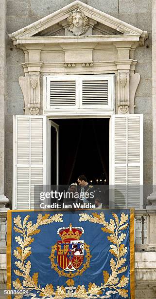 Spanish Crown Prince Felipe de Bourbon and his bride Letizia look at each other as the Royal couple appear on the balcony of Royal Palace May 22,...