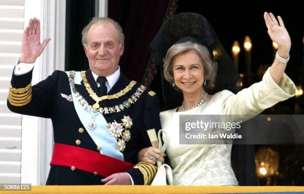 Spanish King Juan Carlos , and Queen Sofia wave as they appear on the balcony of the royal palace after the wedding ceremony of Crown Prince Feleipe...