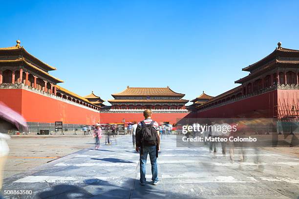 tourist looking at the forbidden city in beijing in a sunny day - beijing tourist stock pictures, royalty-free photos & images