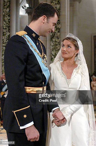 Spain's Crown Prince Felipe de Bourbon stands next to his bride Letizia Ortiz as they marry in Almudena cathedral May 22, 2004 in Madrid.