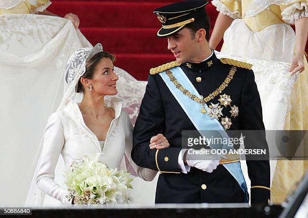 Princess of Asturias Letizia Ortiz and her husband Spanish Crown Prince Felipe of Bourbon smile as they leave Madrid's Almudena Cathedral at the end...
