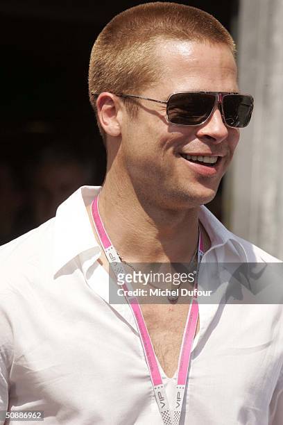 Brad Pitt takes a guided tour of the Jaguar garage as the official guests of Jaguar Racing during a photo-call to promote the film Oceans 12 after...