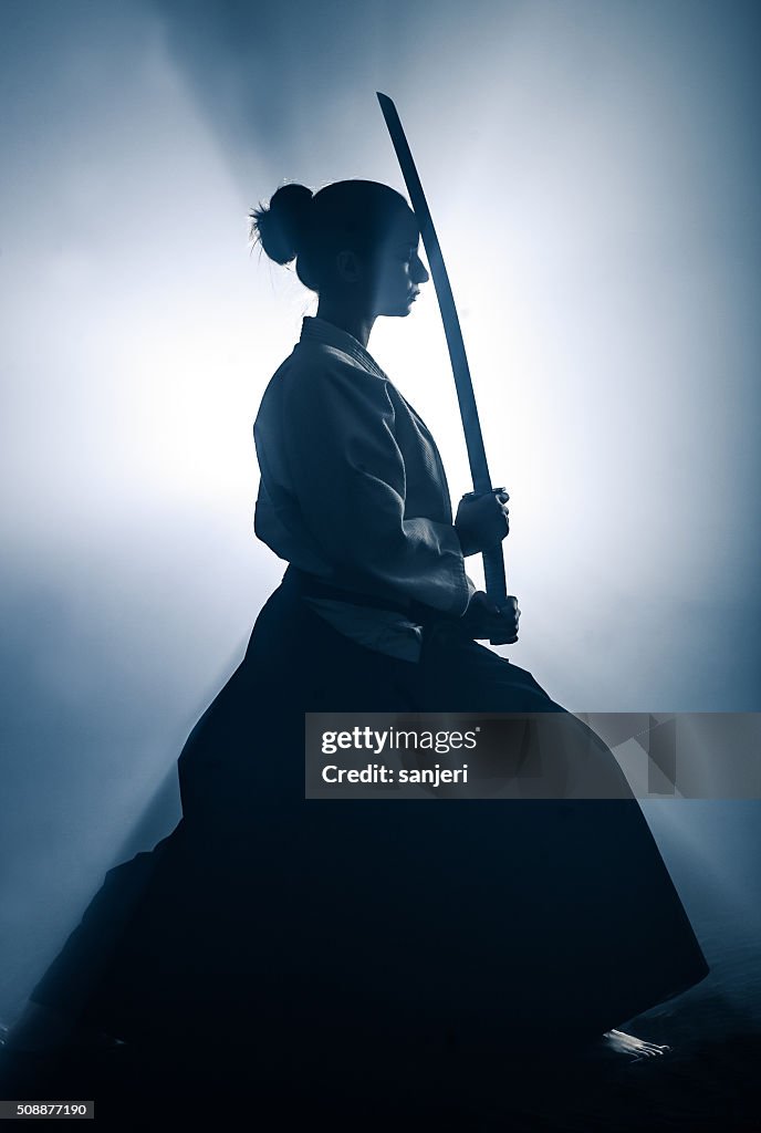 Young woman preparing for aikido training
