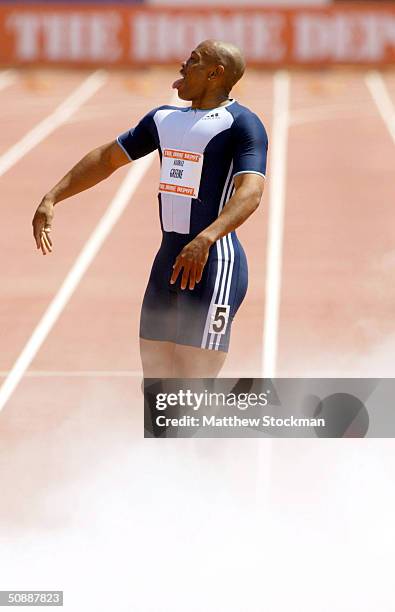 Maurice Greene celebrates as teammates spray his feet with a fire extinguisher after winning the Men's 100 meter with a time of 9.86 during the Home...