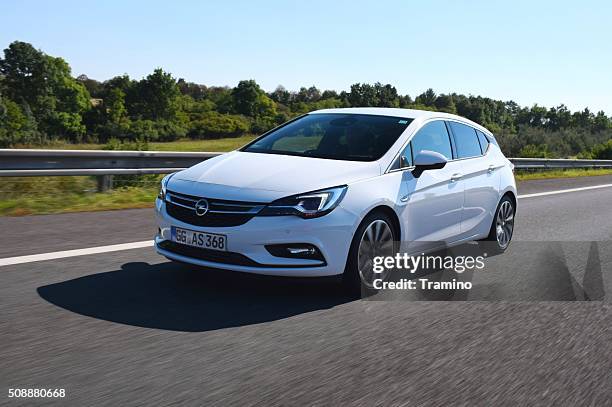 opel astra v driving on the highway - opel vauxhall astra stock pictures, royalty-free photos & images