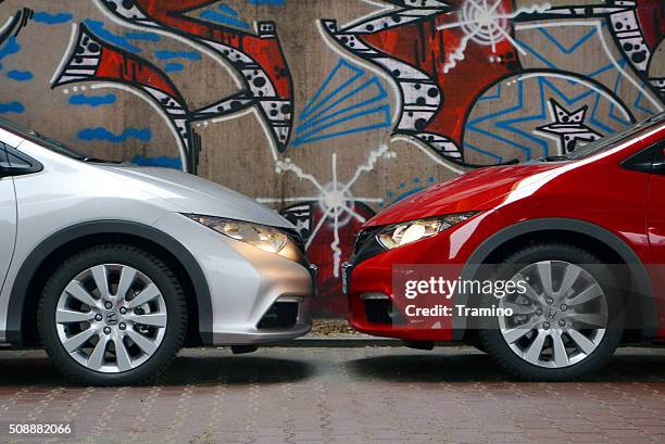 two honda civic cars stopped opposite each other - honda civic stock pictures, royalty-free photos & images