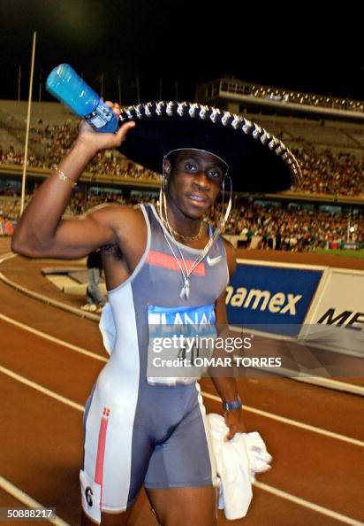 Darrel Brown of Trinidad and Tobago celebrates his victory in the 100
