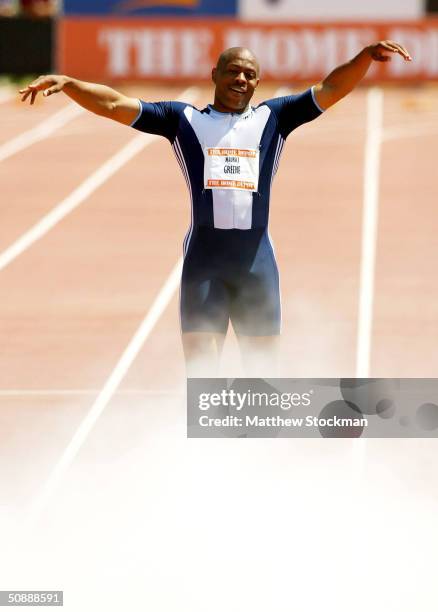 Maurice Greene celebrates as teammates spray his feet with a fire extinguisher after winning the Men's 100 meter with a time of 9.86 during the Home...