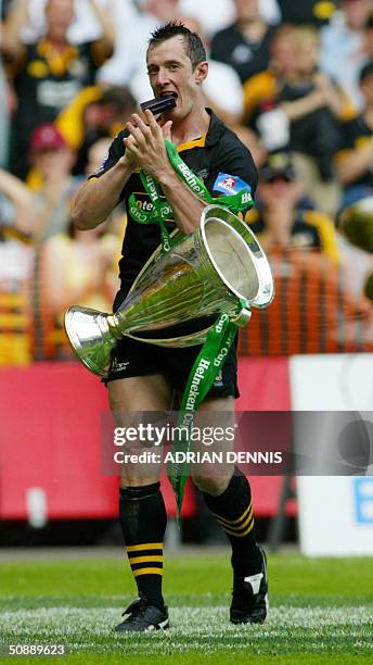 London Wasps Rob Howley carries the Heineken Cup after the Wasps defeated Toulouse 23 May, 2004 in Twikenham, west London. The London Wasps won...