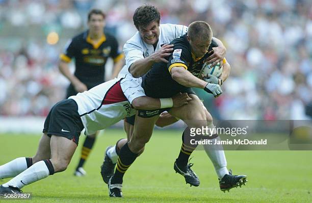 Paul Volley of Wasps is tackled by Fabien Pelous of Toulouse during the Heineken Cup Final match between London Wasps and Stade Toulousain at...