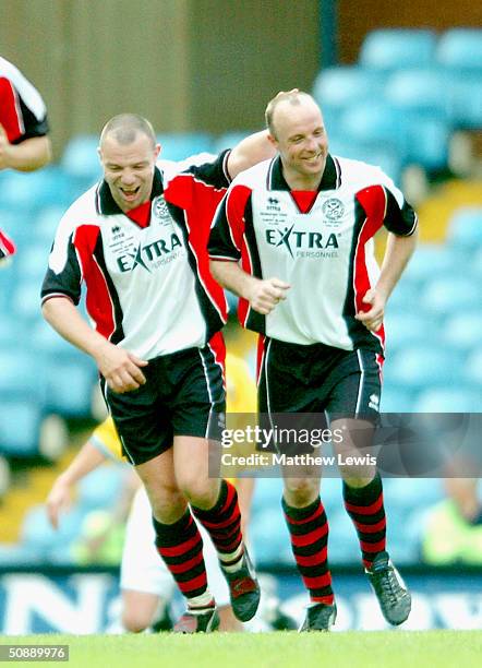 Chris Brindley of Hednesford is congratulated by Darren Simpkin after scoring the winning goal during the FA Trophy Final match between Canvey Island...