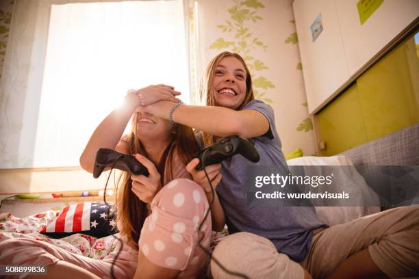 Girl covering friend's eyes in the middle of computer game