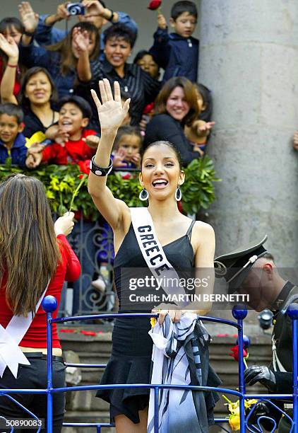 Miss Greece Valia Kakouti wave at a crowd during a parade, 23 May 2004, in Quito. The Miss Universe 2004 contest will take place on 01 June 2004. AFP...