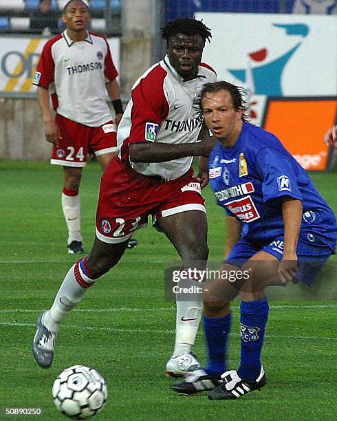 Paris midfielder Hassan Ahamada vies for the ball with Bastia defender Benoit Cauet during their French L1 match Bastia against PSG at Furiani...