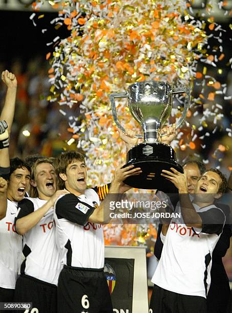Valencia's Ruben Baraja David Albelda Miguel Angel Mista and Vicente Rodriguez celebrate after winning the Spanish soccer league 2004 title and the...