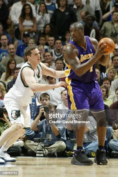 Shaquille O'Neal of the Los Angeles Lakers looks to make his move against Mark Madsen of the Minnesota Timberwolves in Game two of the Western...