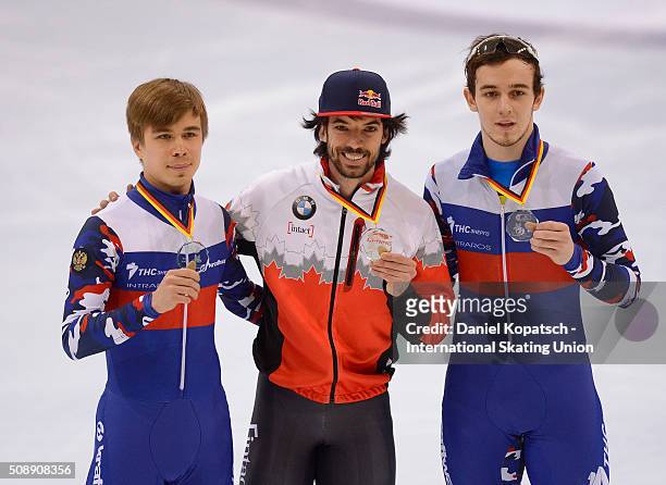Silver medalist Semen Elistratov of Russia , gold medalist Charles Hamelin of Canada and bronze medalist Dmitry Migunov of Russia pose after the Men...